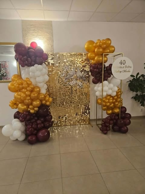 Elegant party backdrop featuring gold sequin curtain, balloons in burgundy, gold, and white colors arranged in organic clusters, with a 40th birthday sign on the right