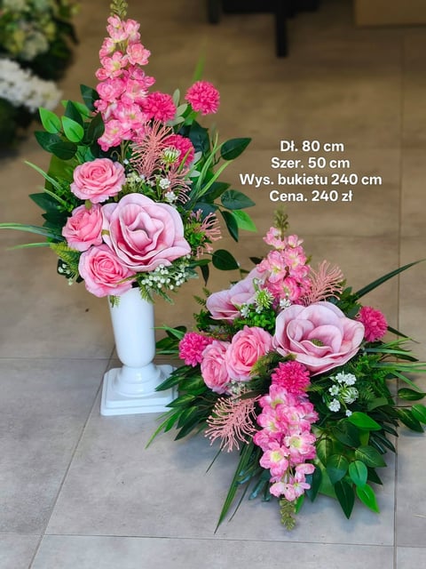 Pink floral arrangement with roses and carnations displayed in a white vase and table centerpiece