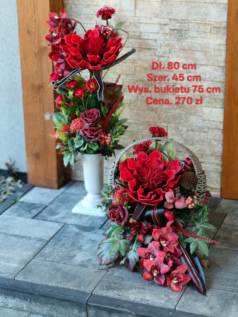 Two red floral arrangements displayed on pavement - a tall arrangement in white vase and a smaller cascading bouquet with product details visible