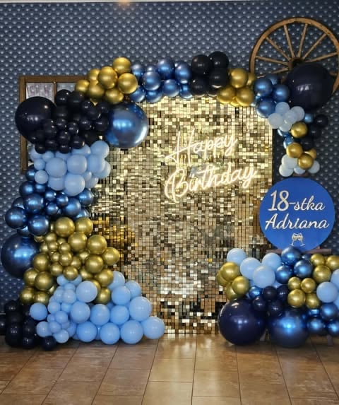 Birthday party backdrop with gold sequin panel, blue and black balloon garland, and Happy Birthday sign for Adrianas 18th celebration